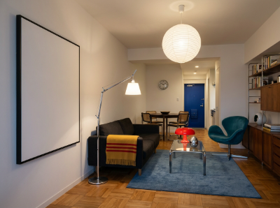 Retro-eclectic studio living room, 1970s Japanese city apartment aesthetic, warm